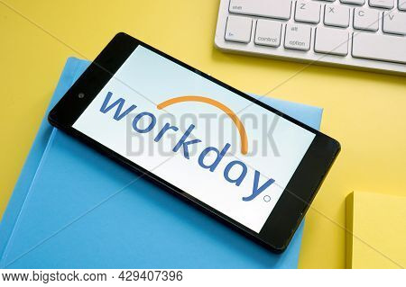 Kyiv, Ukraine - June 30, 2021. Workday Logo On The Smartphone And Notepad.