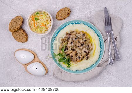 Mashed Potatoes With Butter, Fried Mushrooms With Onions And Salad Of Fresh Vegetables On A Gray Cem