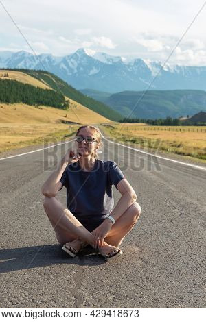 Woman om the Chuysky trakt road in the Altai mountains. One of the most beautiful road in the world.