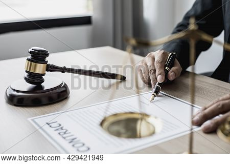 A Small Court Judge's Hammer Is Placed On The Lawyer's Table, The Lawyer Is Advising The Client To H