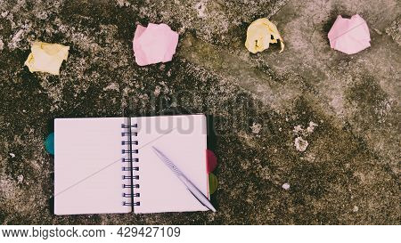 Notebook Pen And Crumpled Paper On Rustic Floor. Mistake Learning, Wrong, Blooper, Error, Regret Say