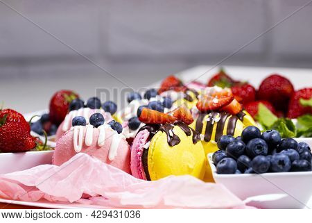 Macaroon, Handmade Beautiful Sweet Food, Dessert With Fresh Strawberries And Blueberries Decorated W