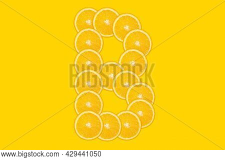 Sliced Orange Alphabet - Letter B. Yellow Background. Fresh Healthy Orange Fruit. Juicy Font.
