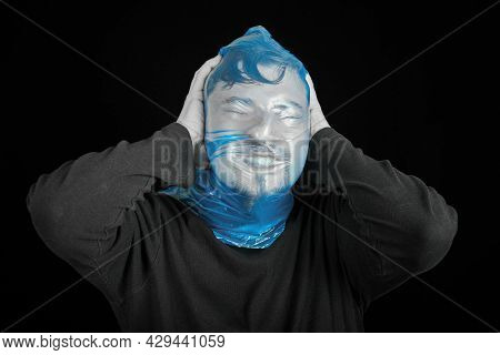 Blue Garbage Bag On Man Head. Exit Bag For Suicide. Self-asphyxiation Concept. Suicide Bag On Man He