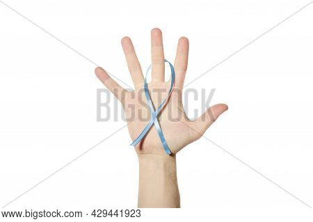 Blue Awareness Ribbon In Hand. Symbol Of Men Health, Childhood Cancer Or Child Abuse Prevention. Whi