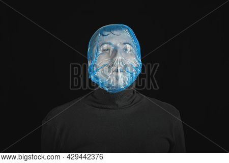 Blue Garbage Bag On Man Head. Exit Bag For Suicide. Self-asphyxiation Concept. Suicide Bag On Man He