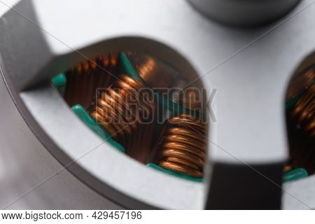 Closely Looking Down Into Tall Copper Coils Or Stators Within A Brushless Electric Drone Motor. Thre