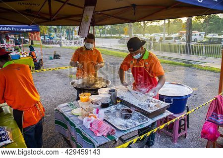 Kuala Lumpur, Malaysia - October 16, 2020: Young Men Frying Youtiao Or Cakoi, A Long Golden-brown De