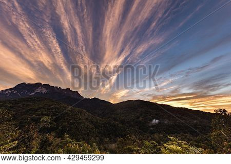 Sunrise At The Mount Kinabalu, Borneo, Sabah, Malaysia. The Sun Comes Up Behind The Highest Mountain