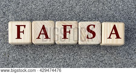 Fafsa (free Aplication For Federal Student Aid) - Acronym On Wooden Cubes On A Gray Background.