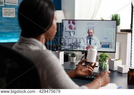 African American Patient Discussing With Therapist Doctor During Online Videocall Meeting Conference