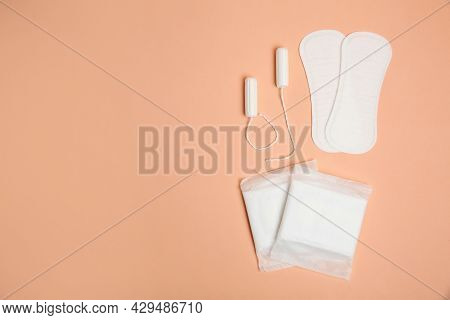 Menstrual Pads, Tampons And Pantyliners On Pale Orange Background, Space For Text
