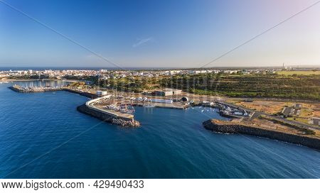 Aerial. The Maritime Dock In The Portuguese City Of Sines And The Sailboat Is Moored For Tourist Exc