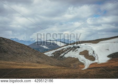 Scenic Highlands Landscape With Small Glacier High In Mountains On Hills On Background Of High Snowy