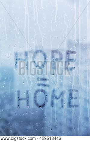 Foggy Glass On Window With Written Finger Word Yellow Color Hope Is Home Concept Photo With Copy Spa