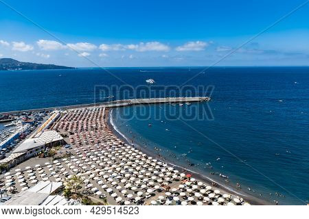 Sorrento, Italy - August 26 2020: Small Beach Full Of Colorful Sunbeds And Umbrellas