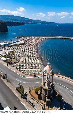 Sorrento, Italy - August 26 2020: Small Beach Full Of Colorful Sunbeds And Umbrellas