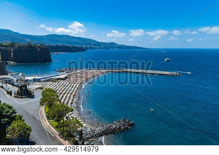 Sorrento, Italy - August 26 2020: Small Beach Full Of Colorful Sunbeds And Umbrellas