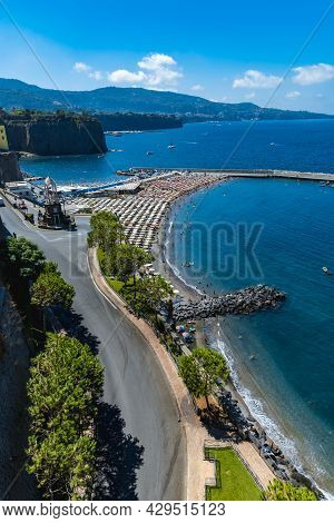 Sorrento, Italy - August 26 2020: Small Beach Full Of Colorful Sunbeds And Umbrellas