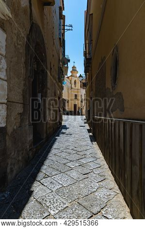 Sorrento, Italy - August 26 2020: Narrow Street With Church Building At The End With Small Dome