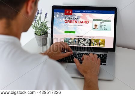 Man With Laptop With United States Permanent Resident Card Website