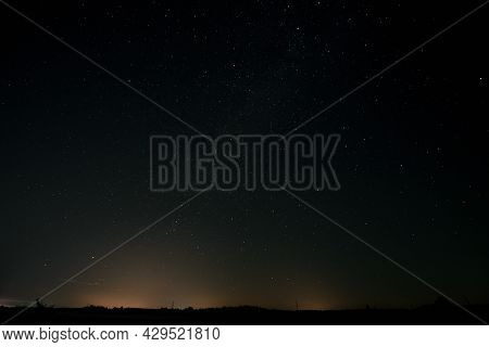 A Dark, Moonless Night. You Can See Shining Stars In The Black Sky, You Can See A Fragment Of The Mi