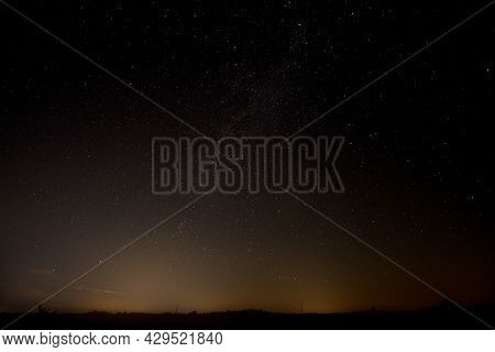 A Dark, Moonless Night. You Can See Shining Stars In The Black Sky, You Can See A Fragment Of The Mi