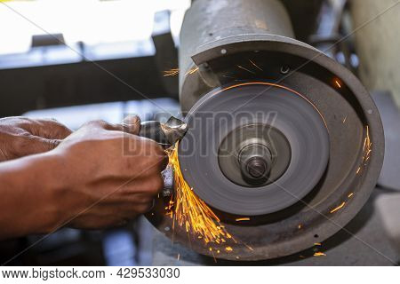 The Machine Operator Grinding The Drill Tool With Abrasive Wheel. The Cutting Tools Regrinding Proce