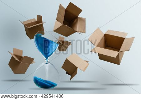 Cardboard Boxes And An Hourglass. Express Delivery In Short Time Concept. Temporary Storage, Limited