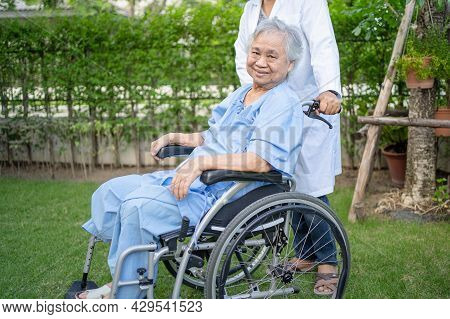 Doctor Help And Care Asian Senior Or Elderly Old Lady Woman Patient Sitting On Wheelchair At Park In