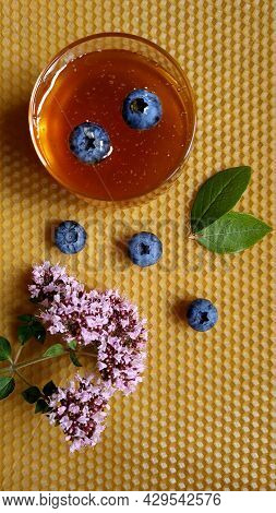 Composition Of Honey, Oregano, Blueberries On Foundation