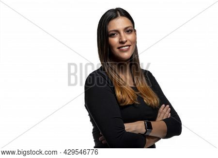 Portrait Of Smiling Young Latina Businesswoman With Arms Crossed On White Background