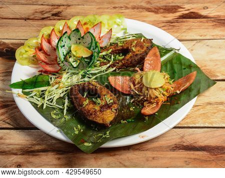 Kerala Fish Curry, Hot And Spicy Baked Fish In Banana Leaves. Pearl Spot Fish Is Marinated With Indi