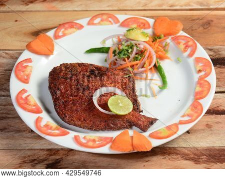 Pomfret Fish Fry - Deeply Fried Pomfret Fishes Which Is Well Garnished With Tomato, Lemon And Onion 