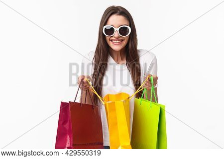 Shopping, Leisure And Lifestyle Concept. Portrait Of Excited Happy Young Girl Likes Shop, Attend Fav
