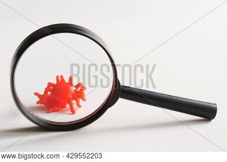 The Toy Is A Virus Under A Magnifying Glass. Concept For The Study And Research Of Changes And Mutat