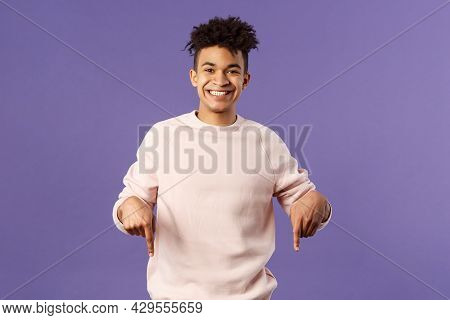 Portrait Of Cheerful, Happy Young 25s Man Recommending Product, Showing Promo Of Product, Delivery S