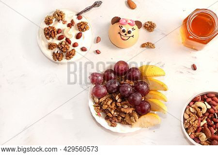 Healthy Breakfast With Ingredients, Flat Lay, Fruit Salad With Muesli, Apricots, Grapes, Honey And A