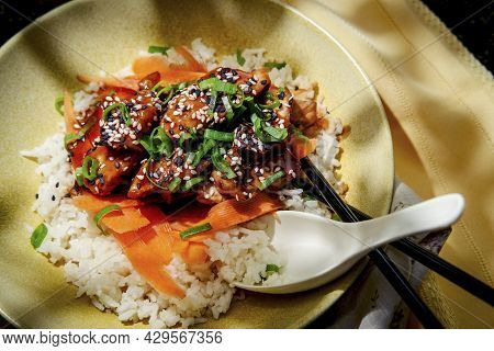 Japanese Teriyaki Chicken Rice Bowl Dinner Garnished With Carrot Ribbons Sliced Green Onions And Tux