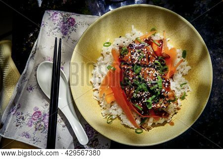 Japanese Teriyaki Chicken Rice Bowl Dinner Garnished With Carrot Ribbons Sliced Green Onions And Tux