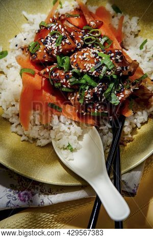 Japanese Teriyaki Chicken Rice Bowl Dinner Garnished With Carrot Ribbons Sliced Green Onions And Tux