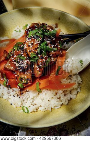 Japanese Teriyaki Chicken Rice Bowl Dinner Garnished With Carrot Ribbons Sliced Green Onions And Tux