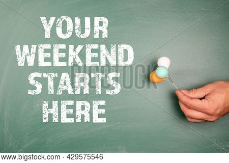 Your Weekend Starts Here. Miniature Balloons In A Mans Hands On A Green Chalk Board