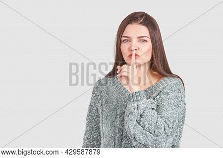 Pretty Young Woman Gesture. Studio Portrait. Female Person. Home Grey Sweater. Isolated Background. 