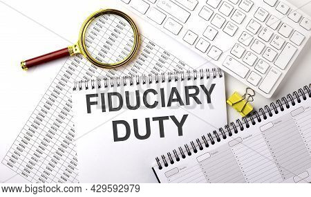 Fiduciary Duty Text Written On Notebook On The Chart With Keyboard And Planning