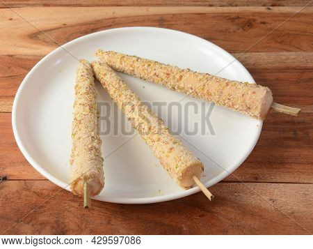 Punjabi Kulfi Is An Indian Traditional Stick Ice Cream, 3 Pieces Of Punjabi Kulfi Served In A White 