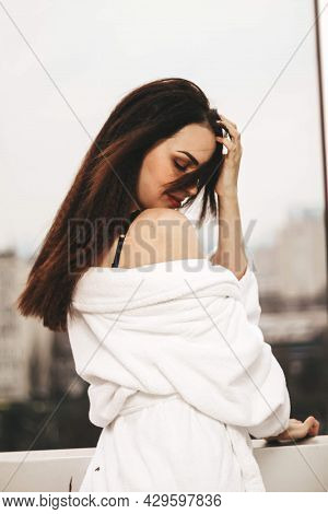 Morning Of A Young Girl. Girl In A Bathrobe On The Balcony