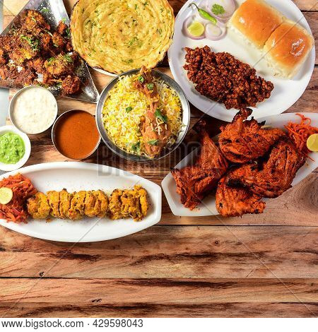 Assorted Indian Food On Wooden Background. Chicken Tikka, Chicken Briyani, Tandoori Chicken, , Masal