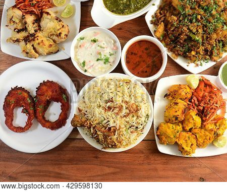Assorted Indian Foods Reshmi Kebab, Afghani Kebab,chicken Biryani And Fish Fry On Wooden Background.