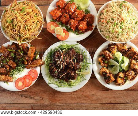 Assorted Indian Food On Wooden Background. Veg Ball Manchurian,chilli Paneer,paneer Manchurian,hakka